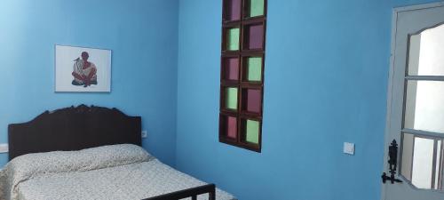 a blue room with a bed and a window at La Ballena Azul in Los Silos