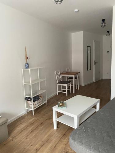 a living room with a couch and a table at 1 Zimmer Studio Apartment in Cologne