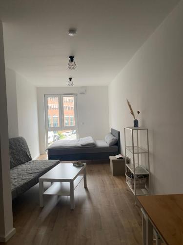 a living room with a bed and a coffee table at 1 Zimmer Studio Apartment in Cologne