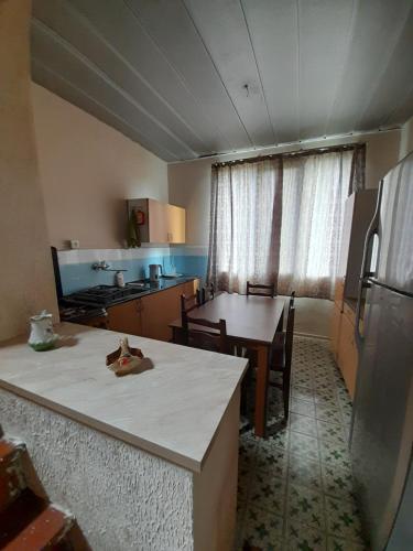 a kitchen with a table and a counter top at Myudro agaraki in Bagdatʼi