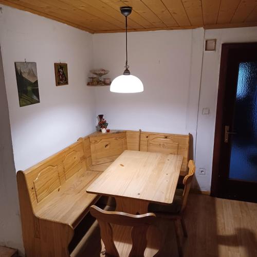 a wooden table and chairs in a room at Ferienhaus Benko in Hieflau