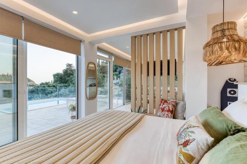 a bedroom with a large bed and a large window at Stavroula Studios in Paleokastritsa