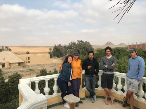 a group of people posing for a picture on a balcony at Sakkara pyramid inn hotel in Cairo