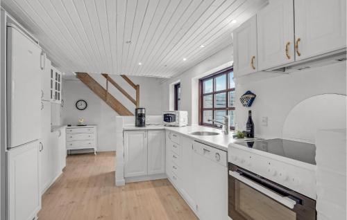 a kitchen with white cabinets and a sink at Lovely Home In Hurup Thy With Wifi in Gettrup