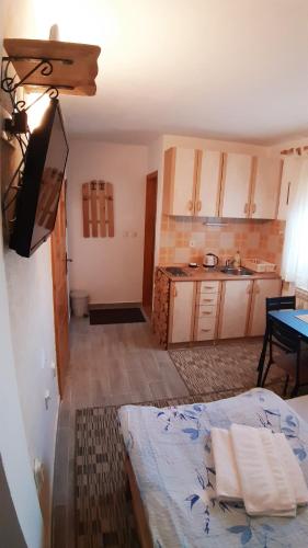 a kitchen with a bed and a table in a room at Apartmani Marija in Jahorina