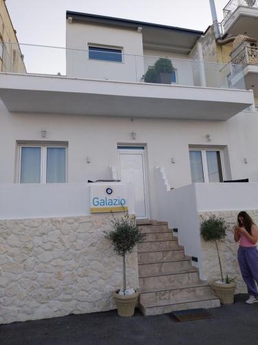 a woman taking a picture of a building at Galazio Seaside Luxury Rooms & Coffee Shop in Platamonas