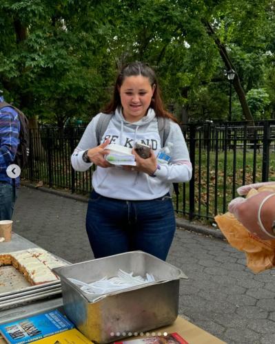 a woman taking a picture of a table of food at Interfaith Retreats in New York
