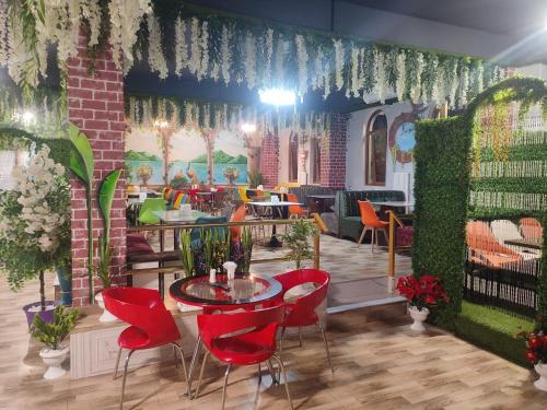 a dining room with red chairs and a table at Delfin Hotel & Restaurants & Spa in Ganja