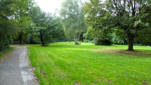 a park with green grass and trees and a path at die Villa, Zimmer 22, DZ in Leverkusen