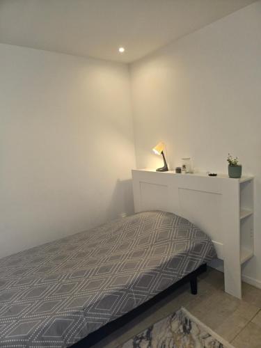 a bedroom with a bed and a white dresser at Studio de 14m2 dans une maison in Cagnes-sur-Mer