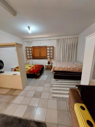 a large room with two beds and a couch at CASA AMPLA e COMFORTAVEL in Campinas