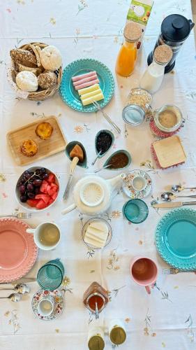 a table filled with plates and bowls of food at Quinta da Cumieira Nova in Seia