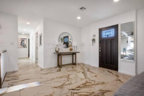 a hallway with a marble floor and a door at 4B House with Pool and BBQ Near Airport and Strip in Las Vegas