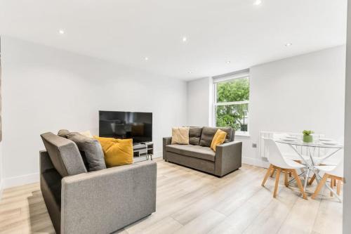 a living room with two couches and a table at LUX St Johns Wood Apartment - Sleeps 7 in London