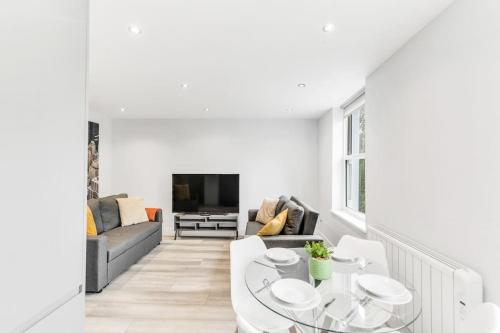 a living room with a couch and a table at LUX St Johns Wood Apartment - Sleeps 7 in London