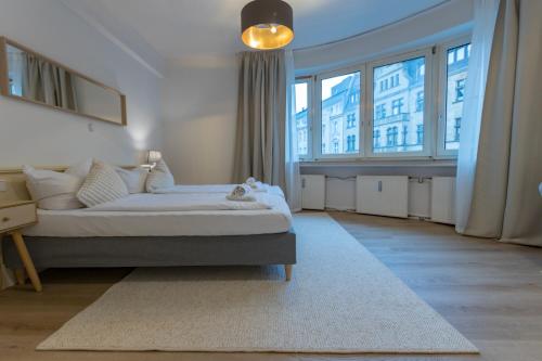 a bedroom with a bed and a large window at Hotel Doerenkamp - Digital Access in Düsseldorf