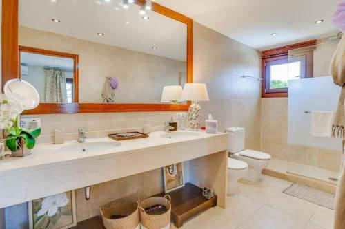 a bathroom with a sink and a toilet and a mirror at Nice house by the sea very near of Palma by Renthousing in Can Pastilla