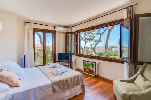 a bedroom with a bed and a fireplace and a chair at Nice house by the sea very near of Palma by Renthousing in Can Pastilla