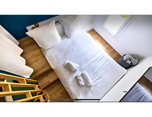 a bedroom with a white bed and a staircase at Séjour mexicain cosy & romantique - CommeChezSoi in Avignon