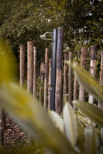 a wooden fence with a light on top of it at Wellnesshuisje Bunga Baco in Lanaken