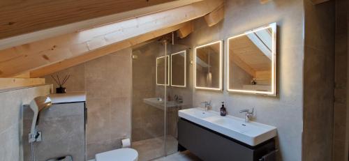 a bathroom with a sink and a mirror at Visionary Hospitality Bassersdorf, Zürich - Premium Apartments in Swiss Style with Free Parking, Washer, Kitchen, Terrace, Vaulted Cellar Event Room, Bus Stop, 15' City & Airport in Bassersdorf