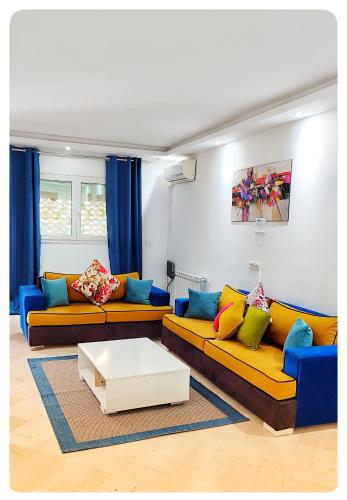 a living room with two couches and a coffee table at Appartement à La Marsa in Tunis