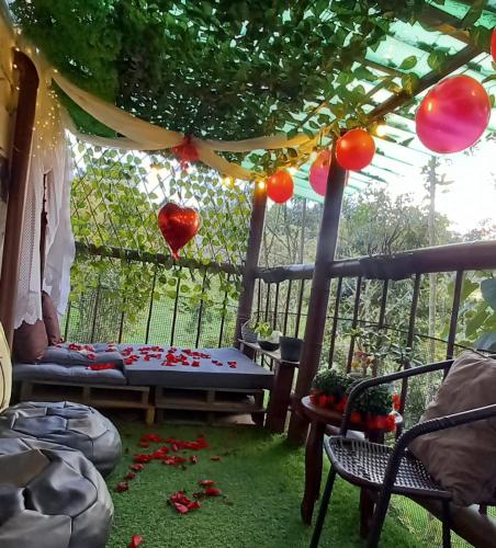 a gazebo with hearts and balloons hanging from it at Boresta House -Santa Elena con vista al Bosque y terraza privada in Medellín