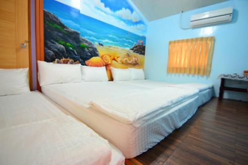 Postel nebo postele na pokoji v ubytování Haichian Hostel