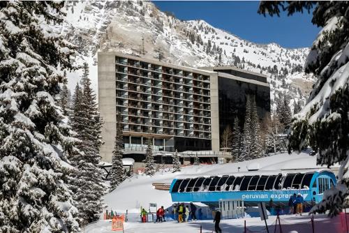 a blue train parked in front of a ski resort at Ski-in Ski-out - The Cliff at Snowbird and Alta in Sandy