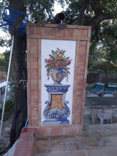 a painting of a vase in a brick wall at Refúgio da Águia in Montargil