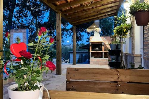 a patio with a wooden table with flowers on it at Refúgio da Águia in Montargil