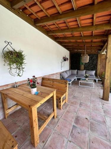 a patio with benches and couches on a porch at Refúgio da Águia in Montargil