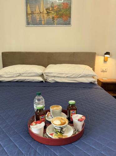 a tray with food and drinks on a bed at Sweet Dreams in Civitavecchia