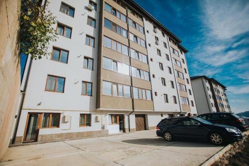 a black car parked in front of a building at Alessandra Studio 2 in Piatra Neamţ