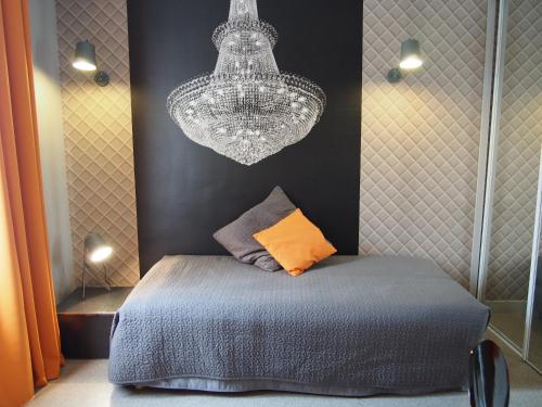 a bedroom with a bed and a chandelier at Porte de Versailles Hotel in Paris