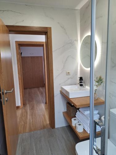 a bathroom with a sink and a mirror at Gerês Valley in Geres