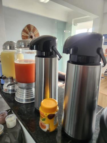 two kettles sitting on a kitchen counter with drinks at BOB Suítes in Porto De Galinhas