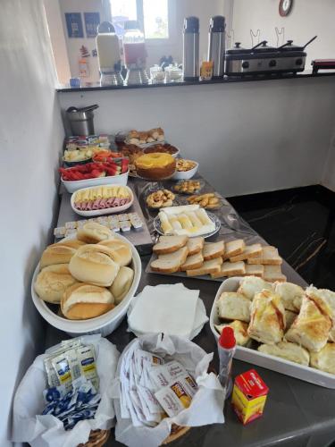 a table topped with lots of different types of food at BOB Suítes in Porto De Galinhas