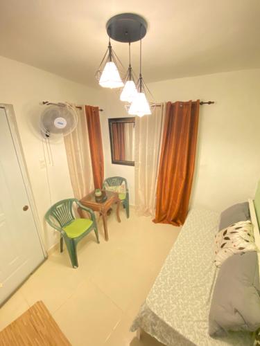 a living room with a table and chairs and a room at Blue Sky 101 in Santo Domingo