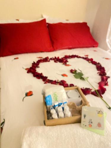 a bed with a heart made out of flowers on it at Blue Sky 101 in Santo Domingo