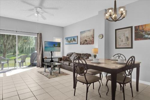 a dining room and living room with a table and chairs at Spring retreat near Disney, Perfect for families in Kissimmee