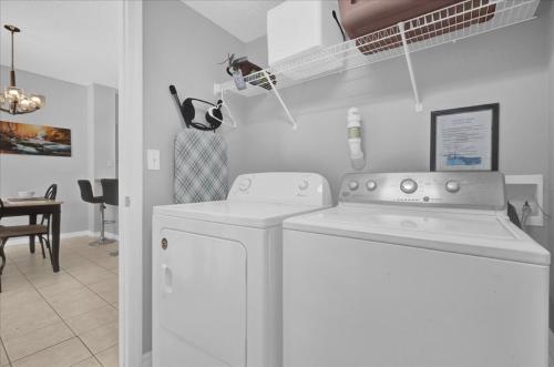a white laundry room with a washer and dryer at Spring retreat near Disney, Perfect for families in Kissimmee