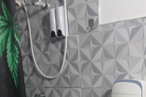 a shower with a hose in a bathroom at Beautiful 1-Bedroom in St Thomas Jamaica in Belfast