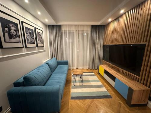 Телевизор и/или развлекательный центр в Szymborskiej 2 Centrum z parkingiem podziemnym Apartamenty LUNA Bialystok