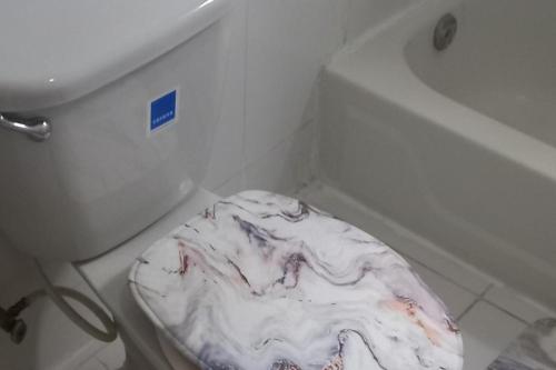 a bathroom with a toilet seat covered in icing at 3 bedrooms Rentals in Port Morant St Thomas in Belfast