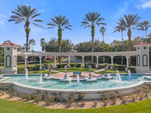 a fountain in a park with palm trees in the background at Spring retreat near Disney, Perfect for families in Kissimmee