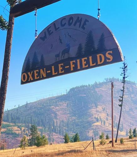 a sign that reads welcome to uneven lie fields at Tent 2 Oxen-Le-Fields Montana in Conner