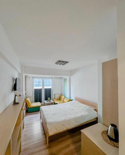 a bedroom with a bed and a living room at Calvin Apartment 10 in Ohrid