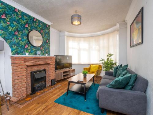 a living room with a couch and a fireplace at Spacious 3BR Home with Driveway Near NEC & Airport in Birmingham