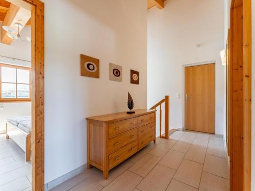 a room with a wooden dresser and a door at Maxima - Ski in - Ski Out in Flecken